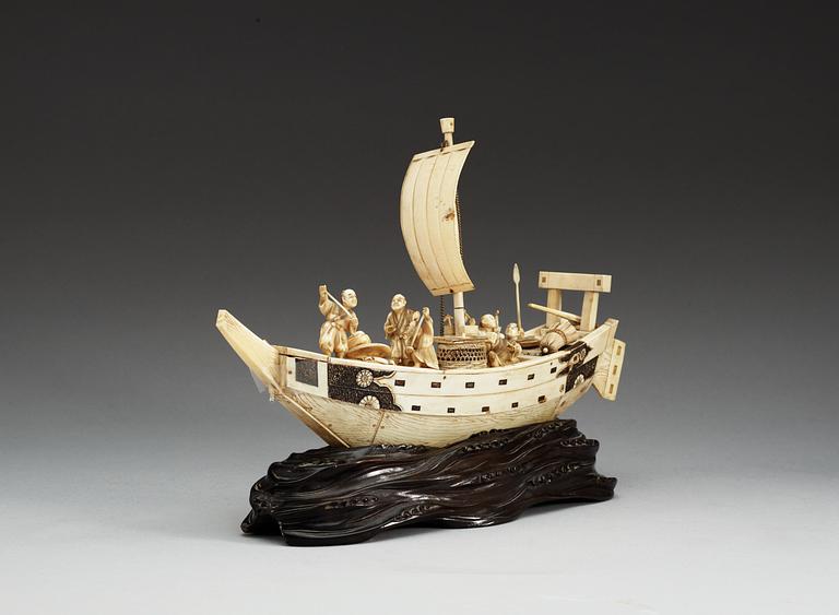 A Japanese ivory model of a ship with fishermen, Meiji period ca 1900.