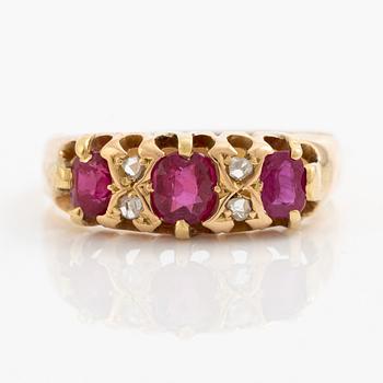A ring 18K gold with rose-cut diamonds and red stones.