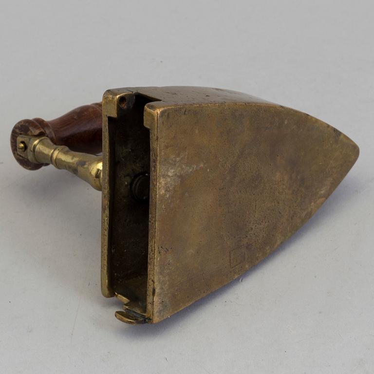 A BRASS IRON, dated 1775.