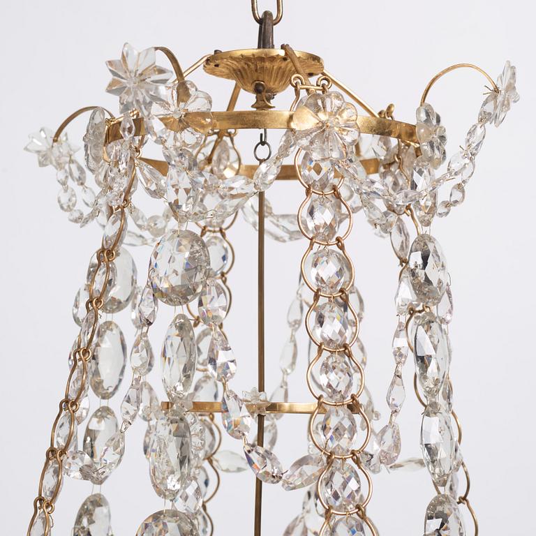 A Gustavian gilt-brass and cut-glass four-branch chandelier by O. Westerberg (master in Stockholm 1769-1881), dated 1795.