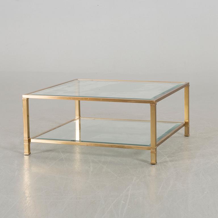 A GLASS TOP COFFEE TABLE.