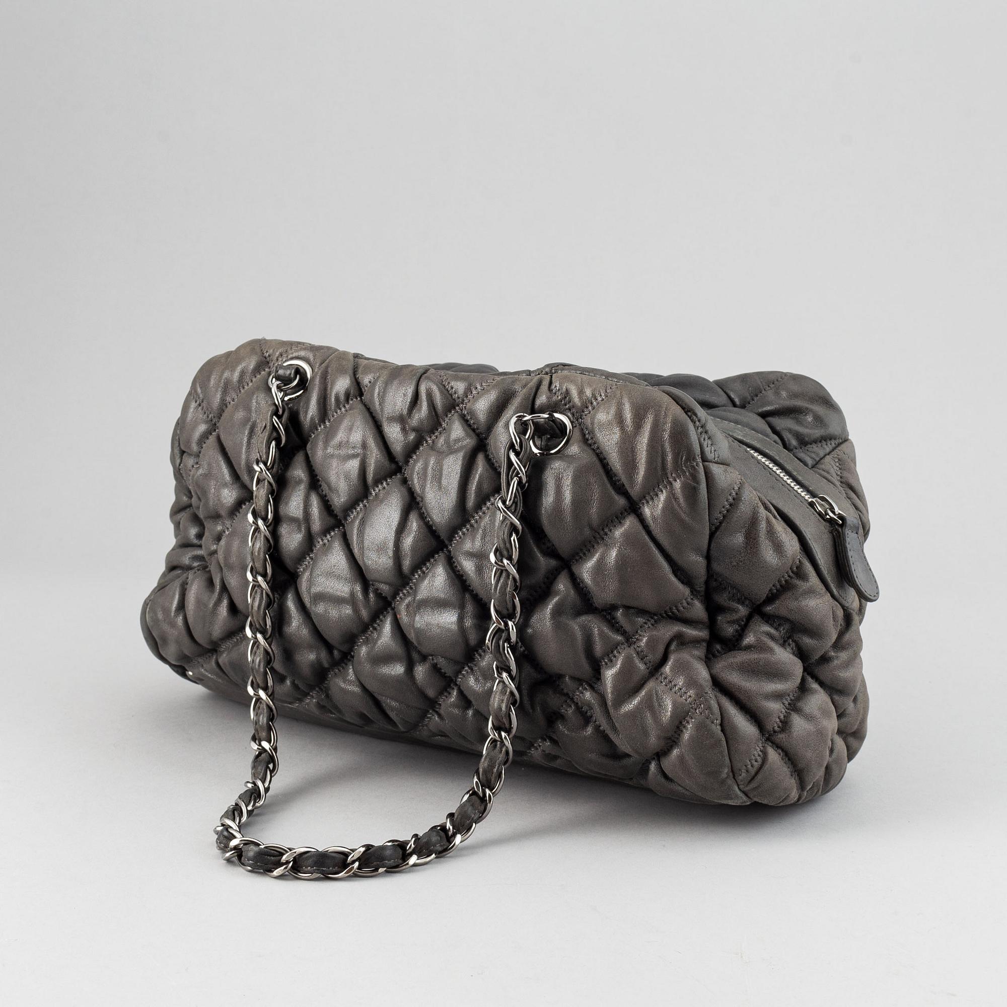 Chanel, a grey leather bag.