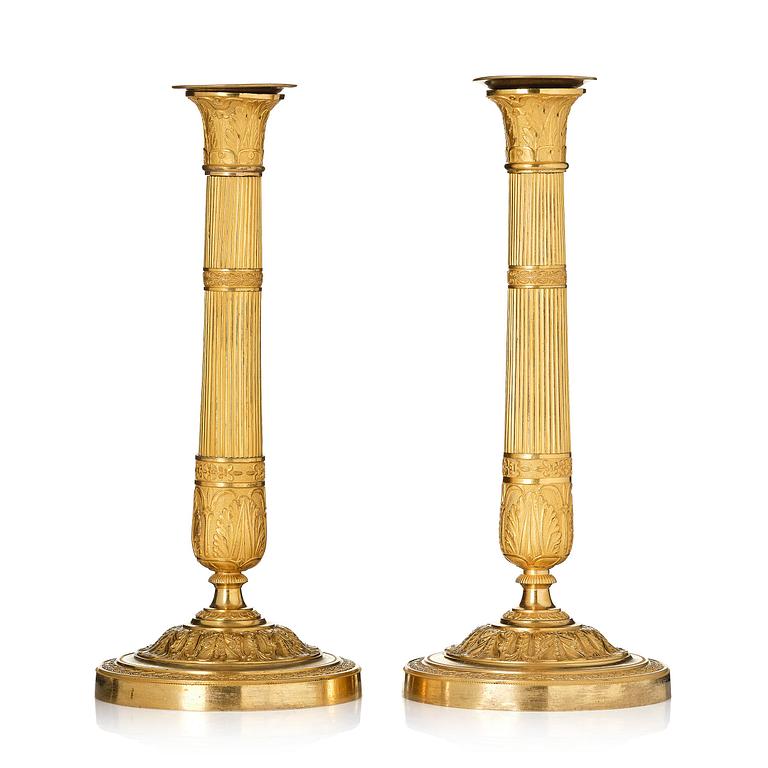 A pair of French Empire ormolu candlesticks, early 19th century.