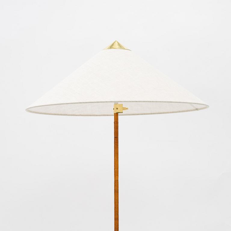 Paavo Tynell, A model 9602 brass and rattan floor lamp with canvas shade from Gubi,