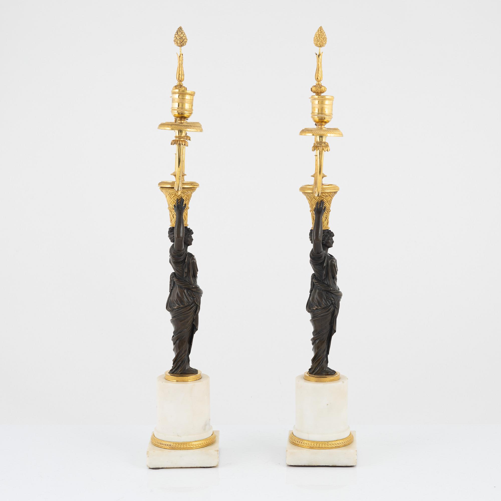A pair of French Louis XVI ormolu, marble, and patinated bronze two-branch candelabra, late 18th century.