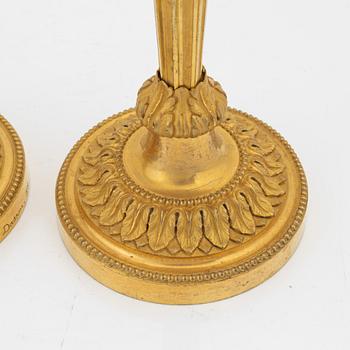 A pair of gilded bronze candelsticks, 19th Century.