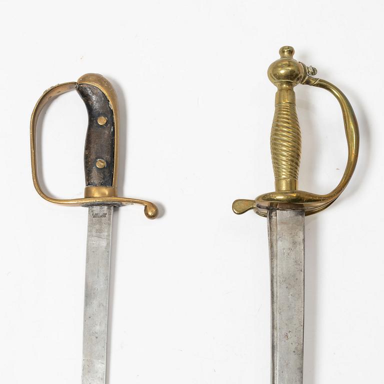 A Swedish police sabre and cutlass, with scabbards.