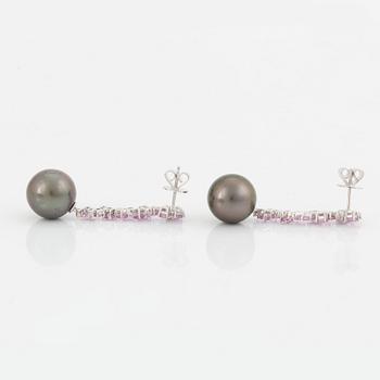 A pair of 18K white gold earrings set with Tahitian cultured pearls and round brilliant-cut diamonds.