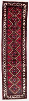 An oriental runner, c. 395 x 100 cm.
