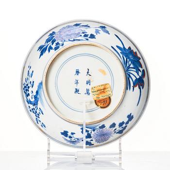 A doucai '100 antiques' dish, Qing dynasty, 18th Century with a Ming mark.