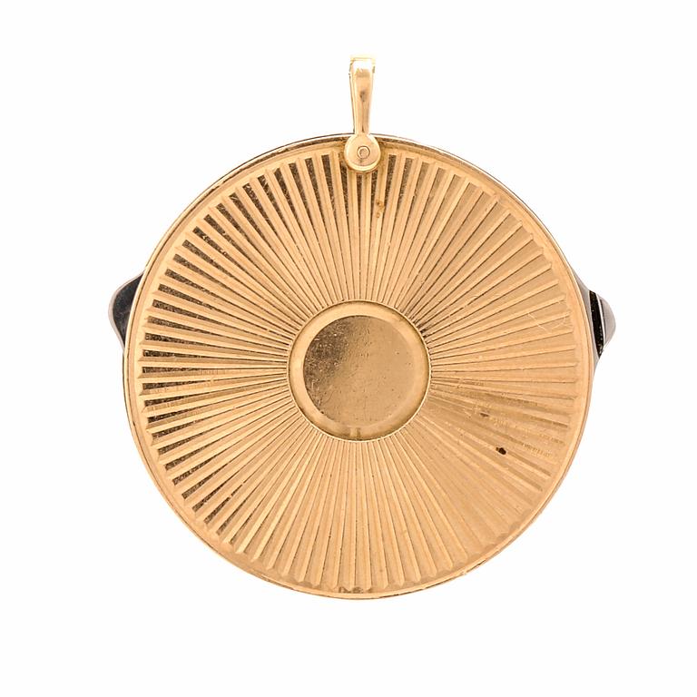 A 14K gold and steel medallion with knives.