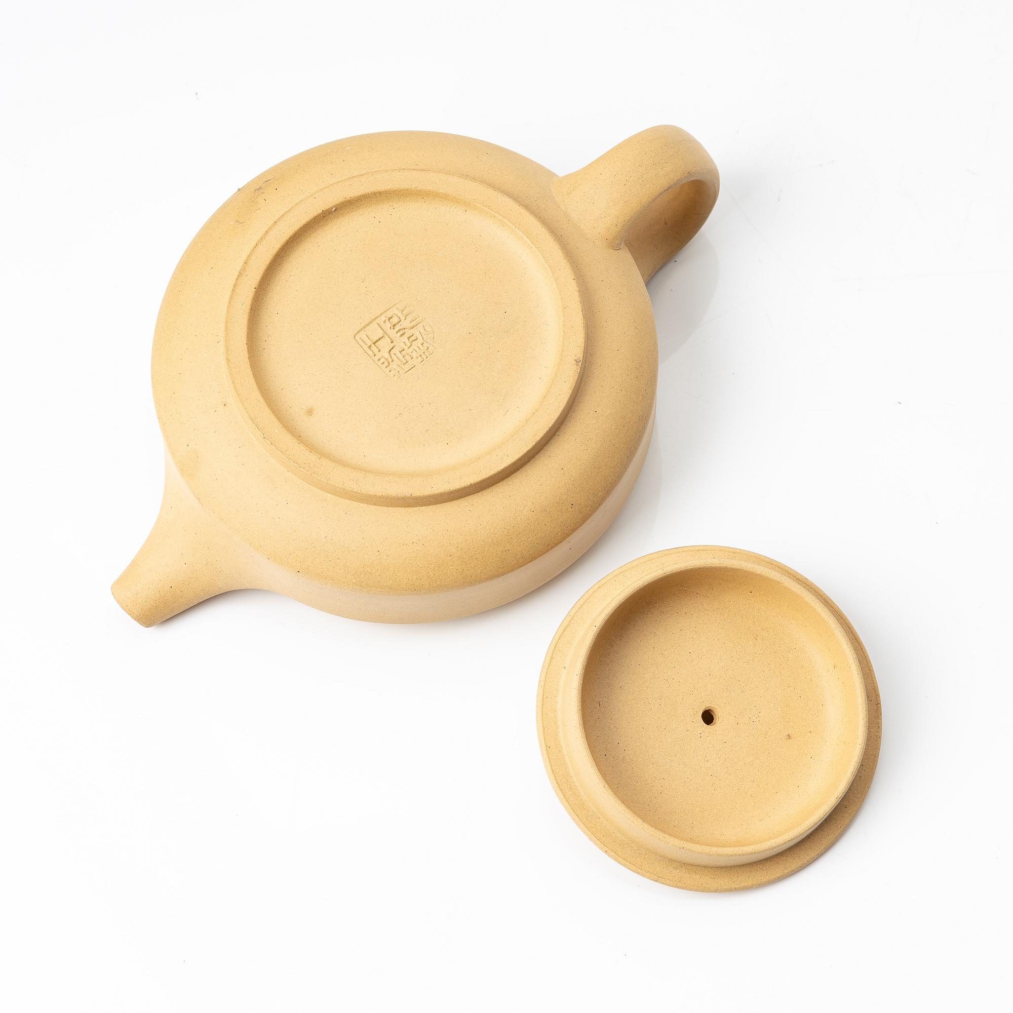 A set of a yellow yixing 'gongfu' teapot and four cups, China, 1980s.