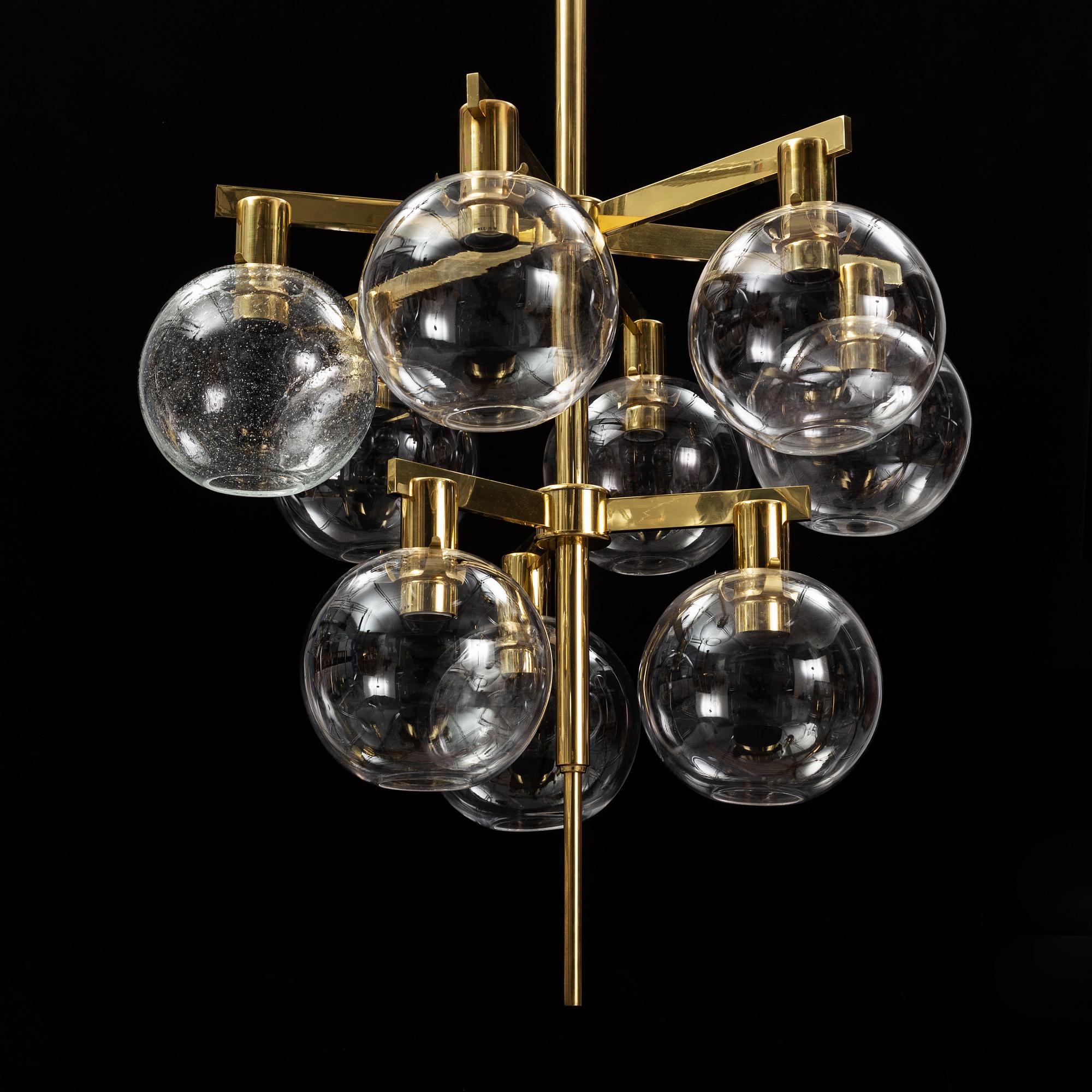 A brass chandelier with glass globes by Hans Agne Jakobsson, Markaryd.