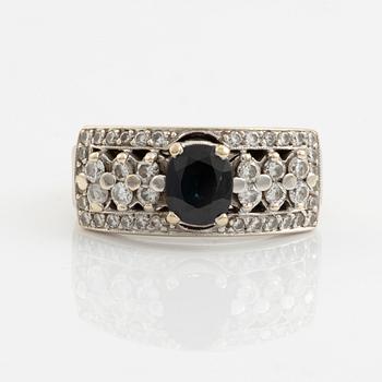 Ring with dark sapphire and brilliant-cut diamonds.
