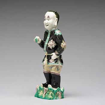 A famille noir figure of a man, Qing dynasty, Kangxi (1662-1722).