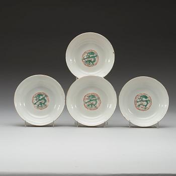 A set of four yellow ground famille rose bowls with covers, early 20th century with Guangxu six character mark in red.