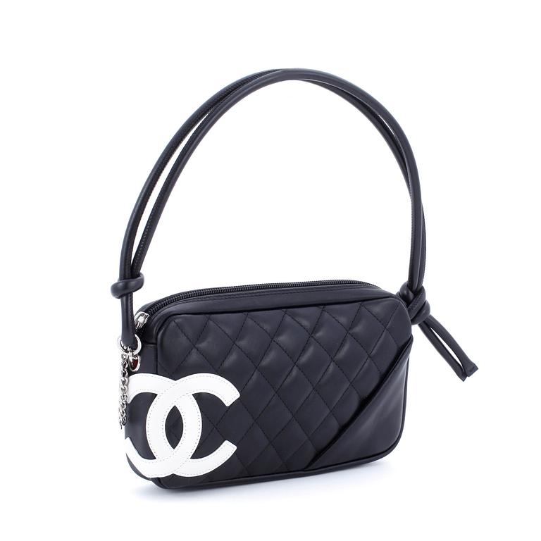 CHANEL, a black leather quilted pochette with short shoulder strap.