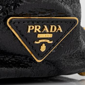 Prada, A black leather and gold stud bag.