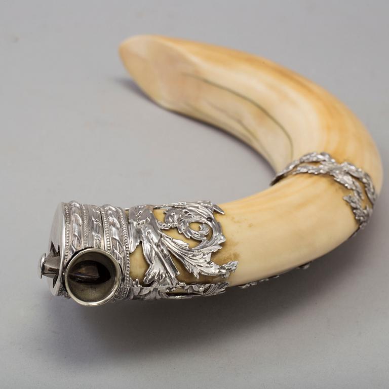 An early 20th century cigar cutter made of a wildboars tusk with silvermountings.