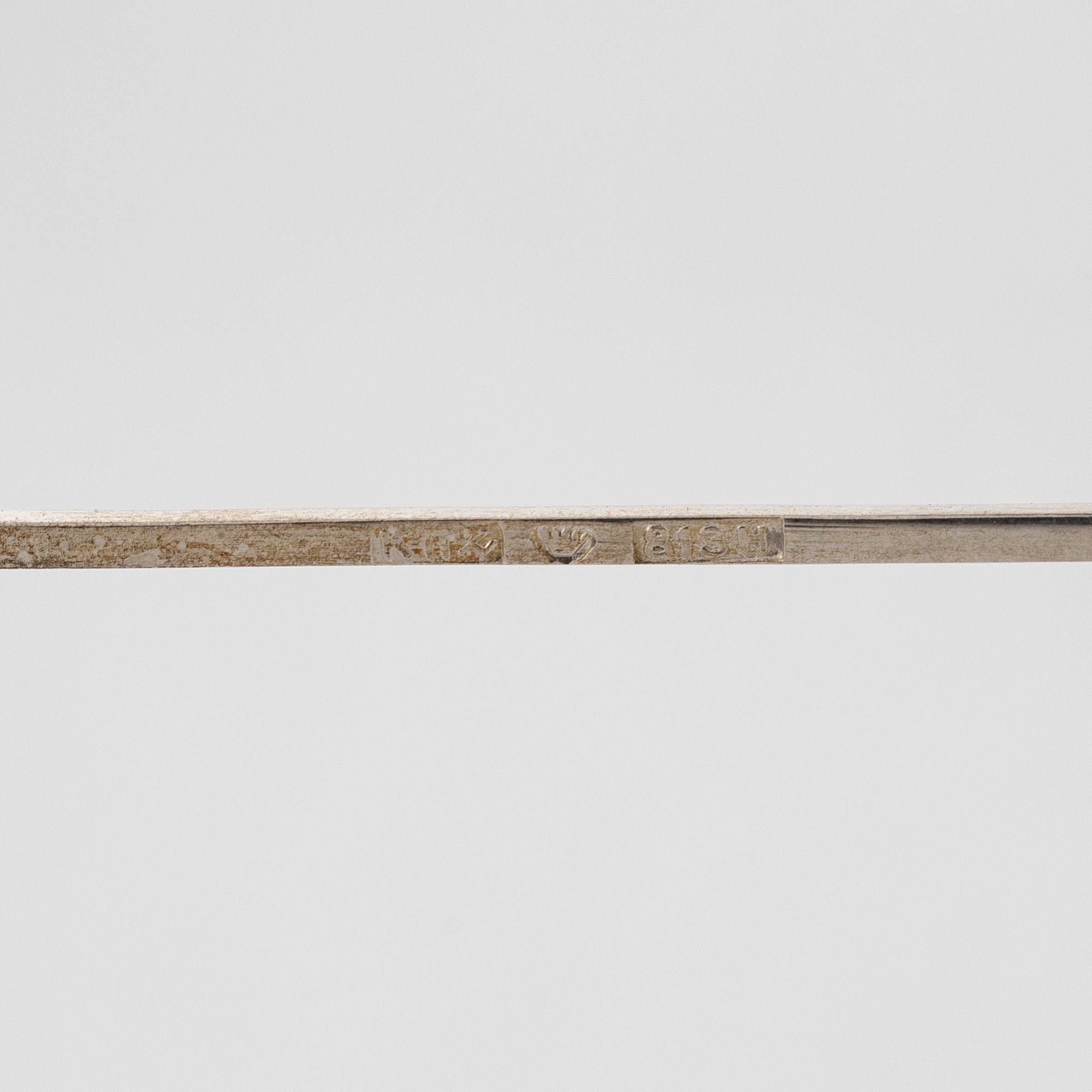 A set of 12 silver glass coasters, Auran Kultaseppä Oy Turku 1935 and 1983, and cocktail sticks, 12 pcs silver.