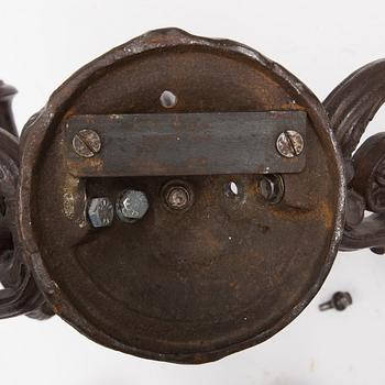 An early 20th century cast iron vall sconce candleholder for five candles.