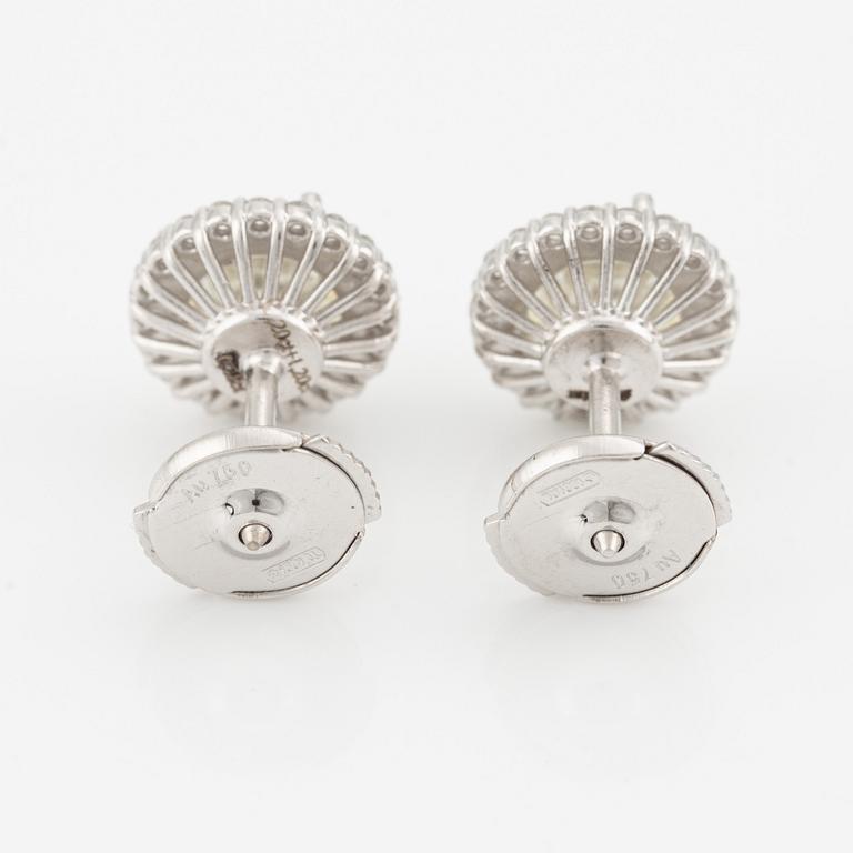 A pair of 18K gold earrings with round brilliant-cut diamonds.