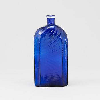 A late 18th or early 19th century glass bottle.