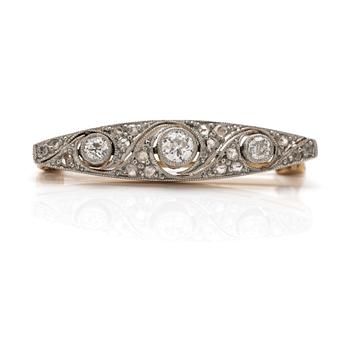 A 14K gold and platinum brooch with diamonds.