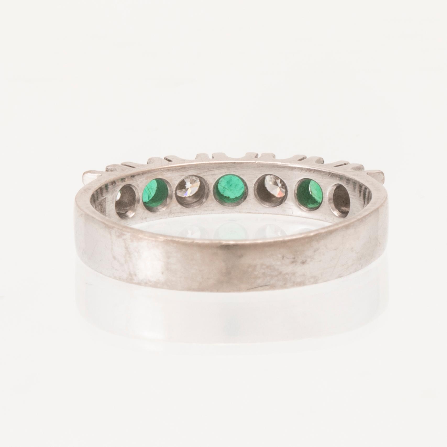 Ring half-eternity 18K white gold with round faceted emeralds and diamonds, Heribert Engelbert Stockholm 1981.
