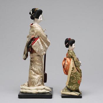 Two Japanese dolls and a box with minitures, 20th Century.