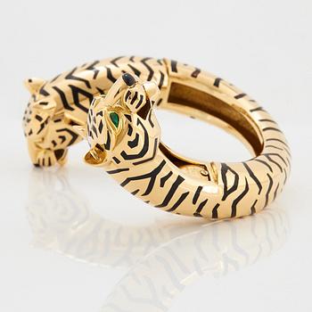 Cartier "Panthère" an 18K gold and enamel bracelet set with emeralds.