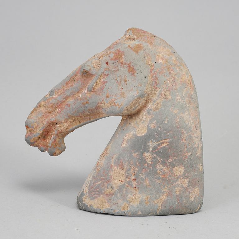 A pottery model of a horses head, Han dynasty (206 BC-220 AD).