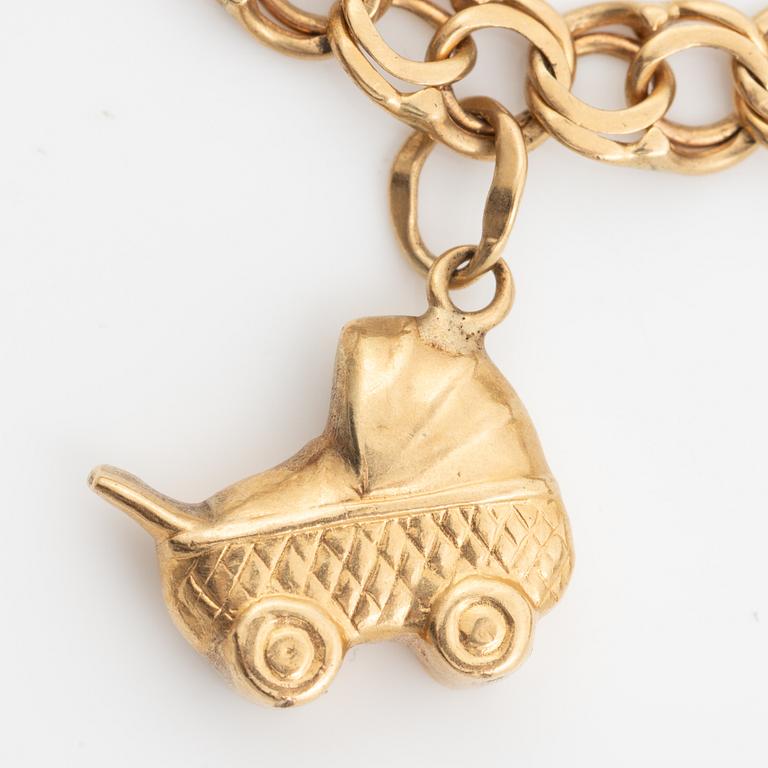 Bracelet, 18K gold bismarck link. With charms.
