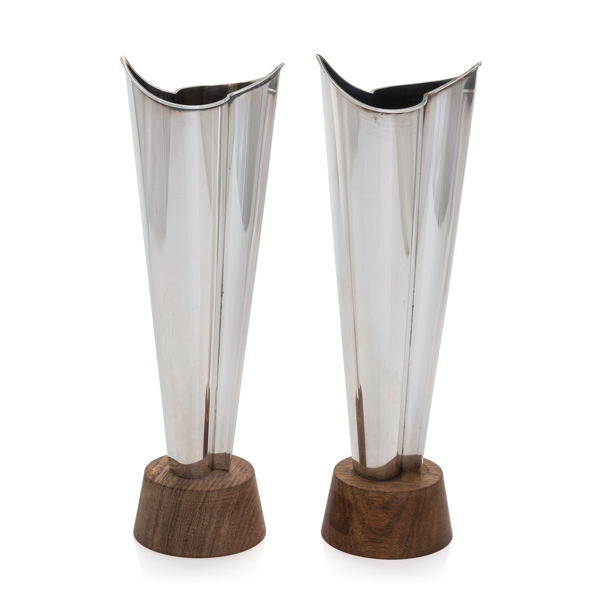 Tapio Wirkkala, two silver and teak 'Flame' vases, Kultakeskus, Hämeenlinna 1962 and 1964.
