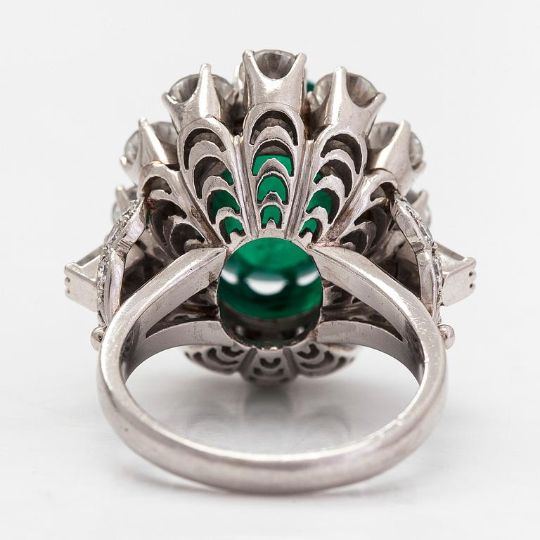 A platinum ring, oval cabochon-cut emerald approx. 8.50 ct, and diamonds totalling 2.84 ct according to certificate.