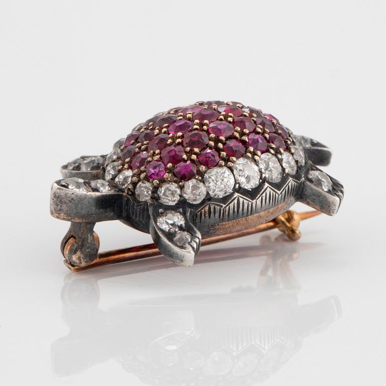 A silver and 14K gold brooch set with old-cut diamonds and rubies.