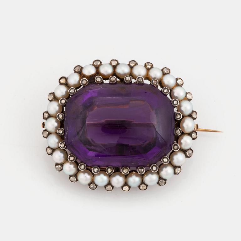 A silver and gold brooch/pendant set with an amethyst and pearls and rose-cut diamonds.