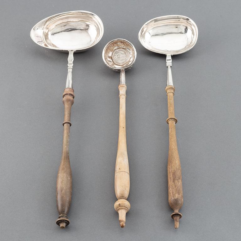 Two 19th century Swedish silver soup-ladles and a silver brandy-ladle.
