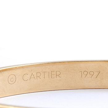 ARMRING, 18k guld besatt med diamant, ca 0,05 ct. Cartier. Vikt ca 39 g.