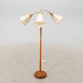 A brass and teak floorlamp from the mid 1900's.