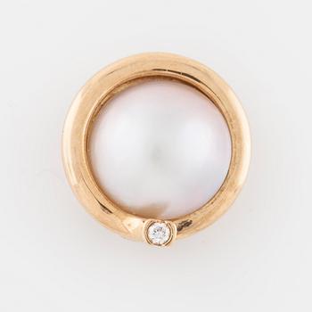 OLE LYNGGAARD, a mabe pearl and brilliant cut diamond clasp.