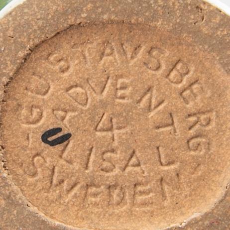 LISA LARSON, a set of four candle sticks.