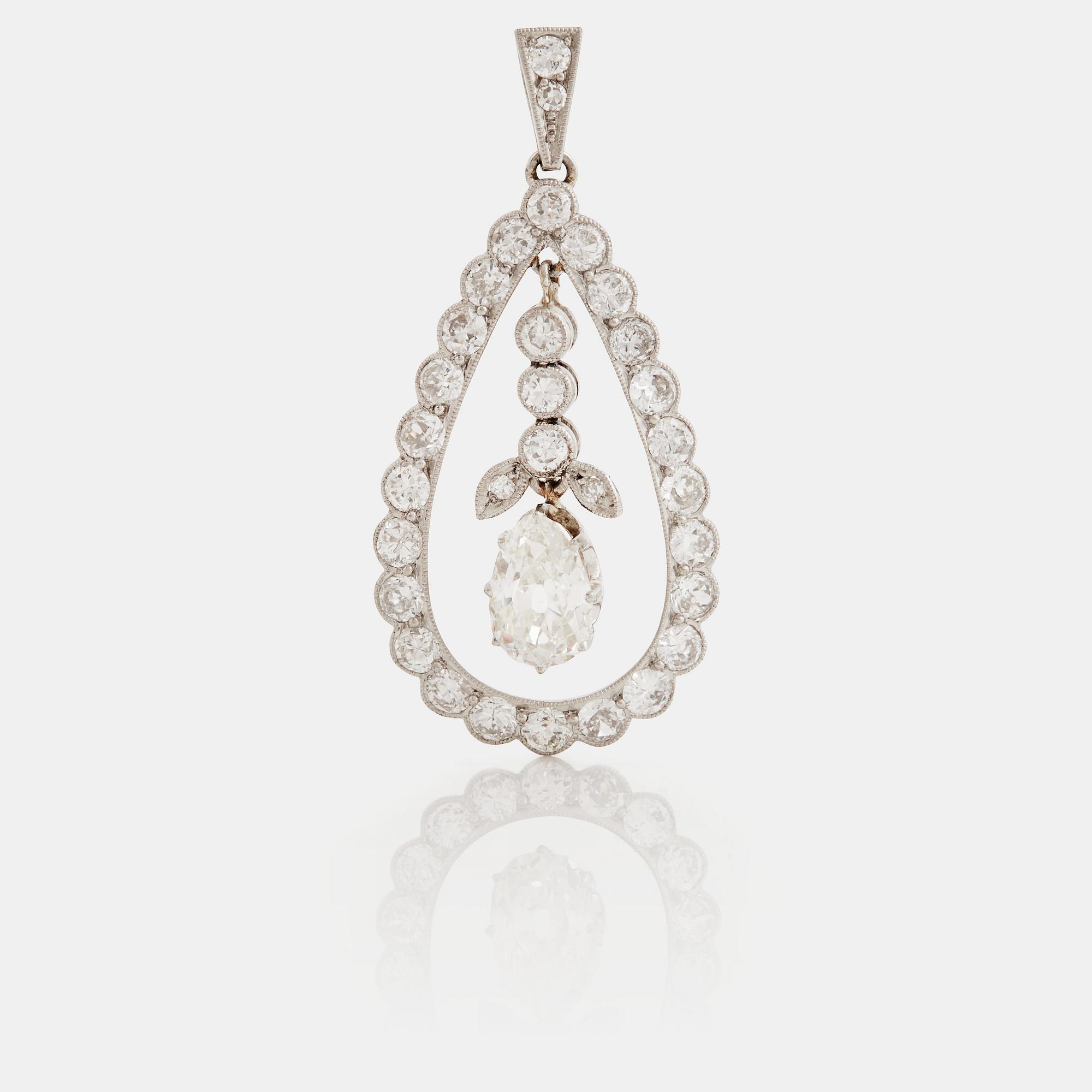 A pendant set with a pear cut diamond surrounded by old cut diamonds.