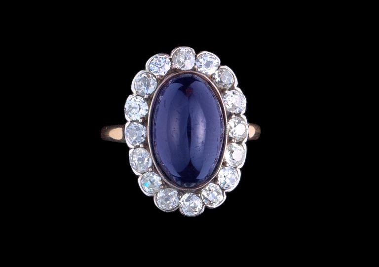 A dark blue sapphire and diamond ring, ca 1900.