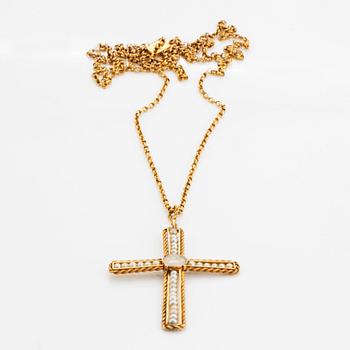 An 18K gold and pearl cross pendant with a gold chain.