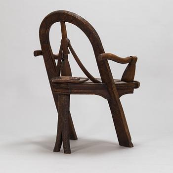 A carved oak wood armchair after V.P. Shutov's design "Arch, axe and gloves", Russia, late 19th century.