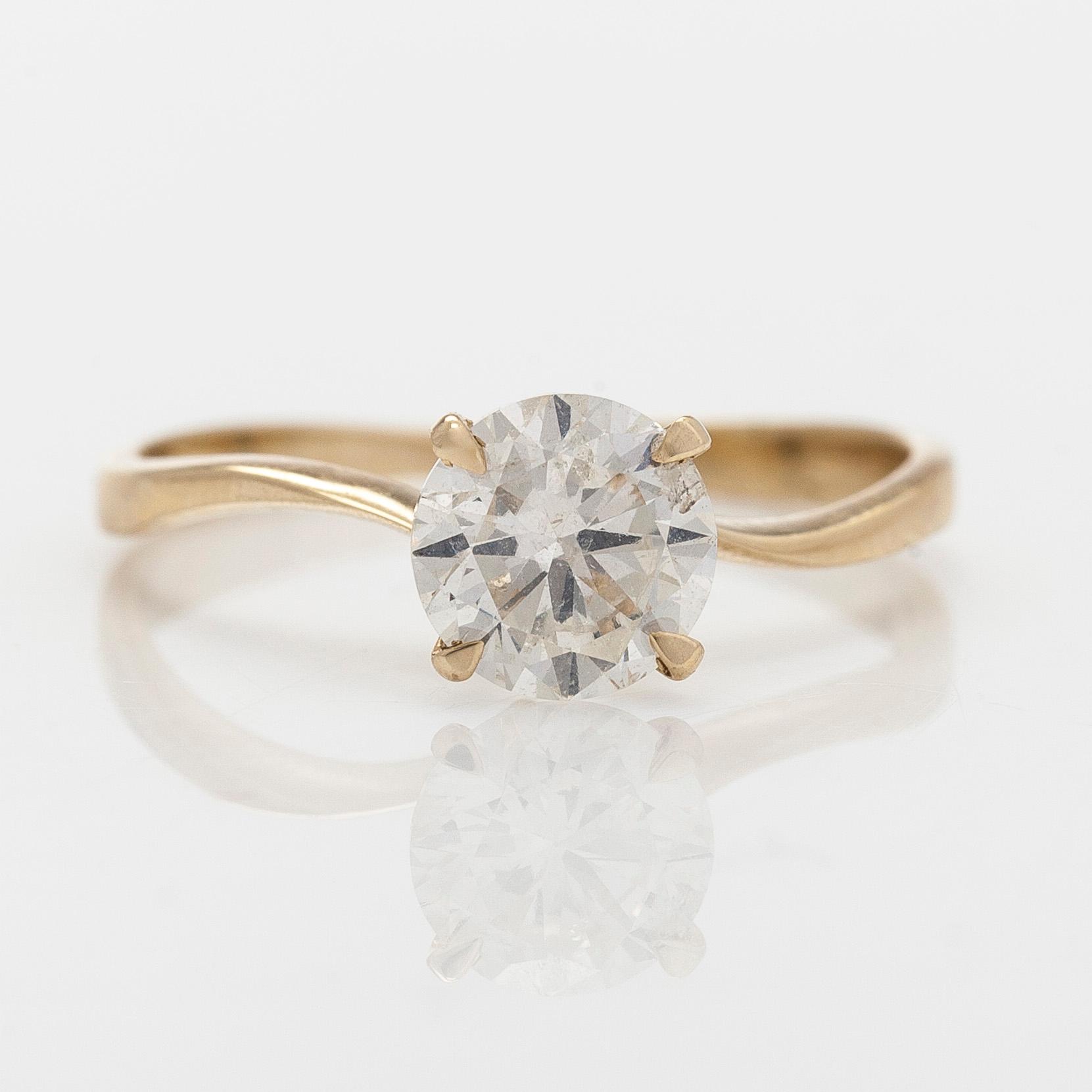 A 14K gold ring with brilliant cut diamond.