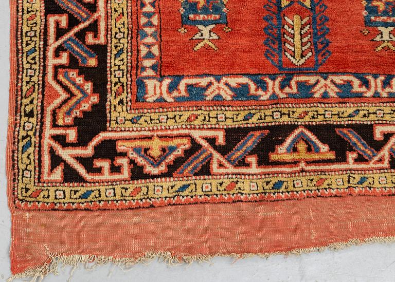 A rug, an antique Anatolian, ca 128 x 104,5-108 cm (as well as ca 8-10 cm flat weave at the ends).