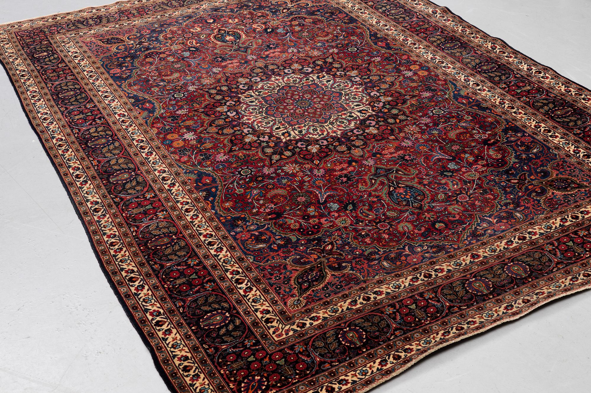 A carpet, semi-antique Mashad/Moud, ca 292 x 214 -218 cm.