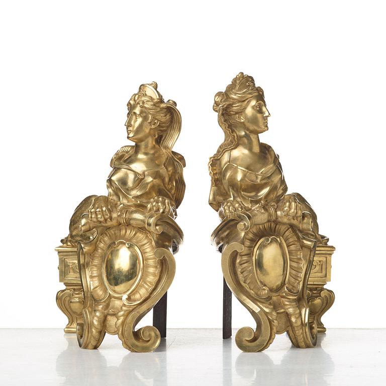 A pair of Louis XV fire dogs, France, mid 18th century, the design of the sphinxes attributed Nicolas Coustou 1658-1733.